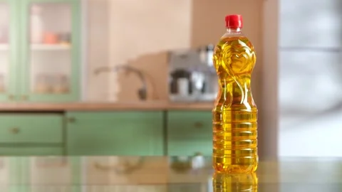 Close up of a hand picking up and then replacing a plastic bottle of vegetable Stock Footage 335153349