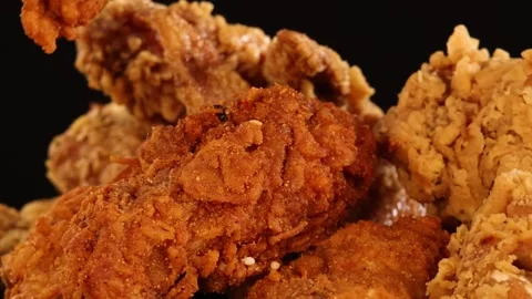 Close Up of Hand Picking Crispy Fried Chicken on Black Background Stock Footage 326847532
