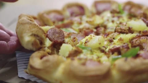 Close-up of a hand picking up a hot slice of Hawaiian style pizza with saus.. 스톡 동영상 335007408
