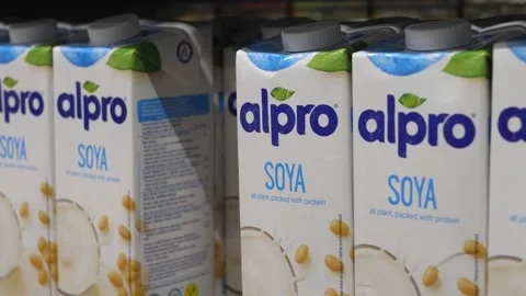 Close up of hand picking a pack of alpro soya milk from the shelf at the store Video stock 149167453