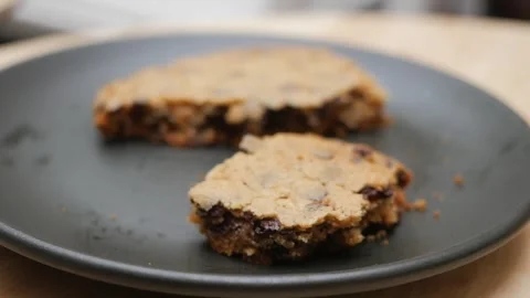 Close up of hand picking up piece of freshly baked chocolate chip cookie fr.. Stock Footage 333032568