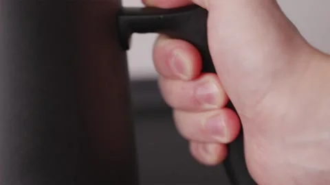 Close-up of hand picking up professional gooseneck kettle handle Stock Footage 332720219