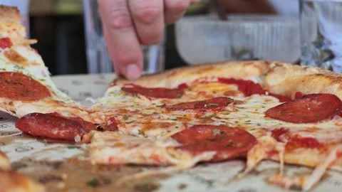 Close-up of hand picking slice from pepperoni pizza Stock Footage 341775385