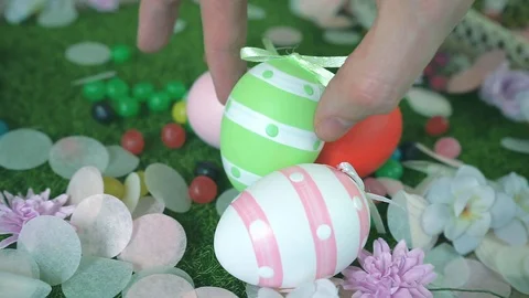 Close-up of hand places or hides a Easter egg between others Stock Footage 101290631