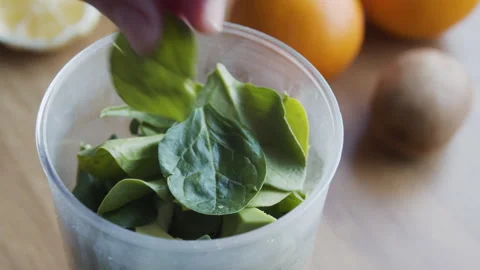 Close-up of a hand placing fresh fruit slices. Stock-Footage 331859978