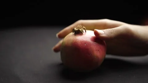 Close Up of a Hand Placing a Grenade on a Dark Background Stock Footage 272184648