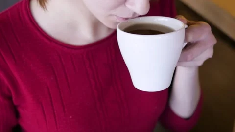 Close-up of hand placing hot ceramic white coffee cup with smoke on saucer over Stock-Footage 148189571