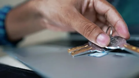 Close-up of a hand placing keys on a laptop keyboard Stock Footage 317131664