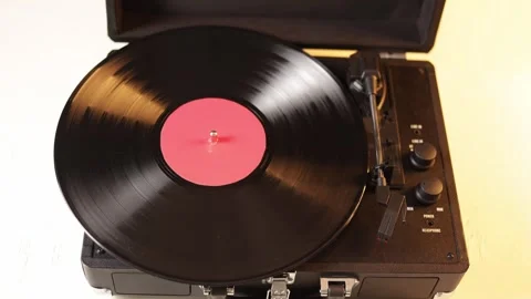 Close-up of a hand placing a vinyl record on a turntable Stock Footage 339004741