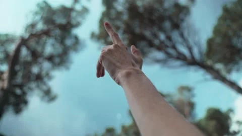 Close-up of a hand playing with air. Beautiful woods on the background. Romantic Stock Footage 191485977