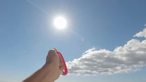 Close up of hand playing and holding a flying kite in the sky Stock Footage 142008626