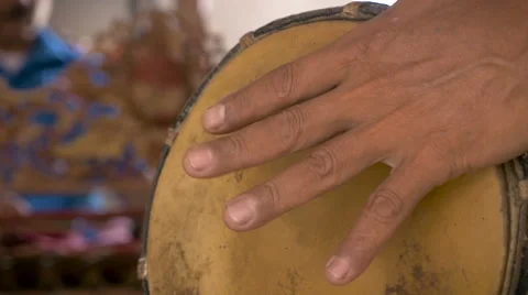Close up of a hand playing an animal skinned hand drum Stock Footage 57639128