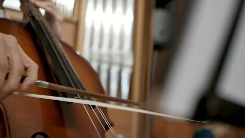 Close-up of hand playing cello indoors Stock Footage 314943569
