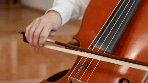 Close-up of hand playing cello indoors Stock Footage 314943663