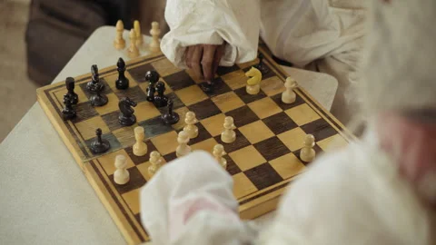 Close Up of Hand Playing Chess with Black Piece on Wooden Board Video stock 329463840