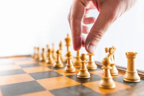 Close up of hand playing chess Stock Photos