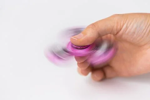 Close up of hand playing with fidget spinner Stock Photos