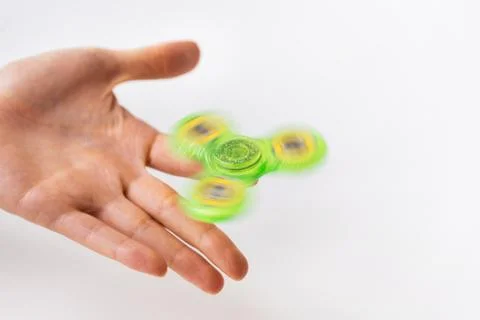 Close up of hand playing with fidget spinner Stock Photos