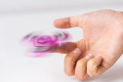 Close up of hand playing with fidget spinner Fotos Stock