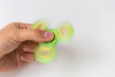 Close up of hand playing with fidget spinner Stock Photos
