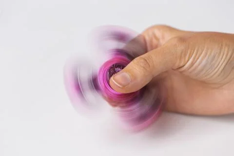 Close up of hand playing with fidget spinner Stock Photos