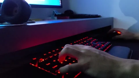 Close up hand playing game using the keyboard keys W A S D on the dark Vídeo Stock 252613797