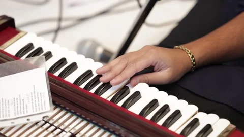 Close up of a hand playing indian classical music instrument harmonium. Stockbeeldmateriaal 316301601