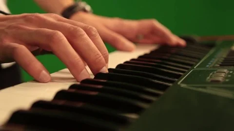 Close-up of hand playing the piano electronic keyboard on green chroma key Stock Footage 81178529