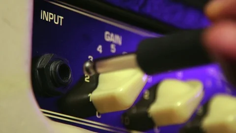 Close up of Hand Plug in and Out Aux from Amplifier Stock Footage 123858558