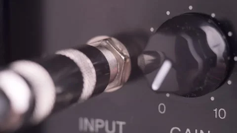 Close up of a Hand Plug In and Out Aux Cable in Amplifier Stock Footage 241549256