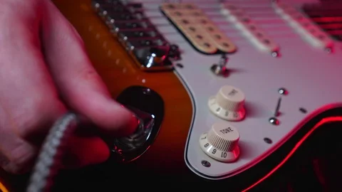 Close up of Hand Plug in the Aux in Electric Guitar Stock Footage 123857689