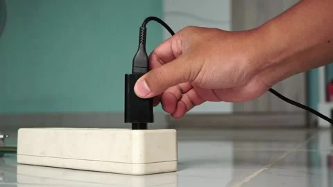 Close up hand plug the charger from charging station Stock Footage 209841310