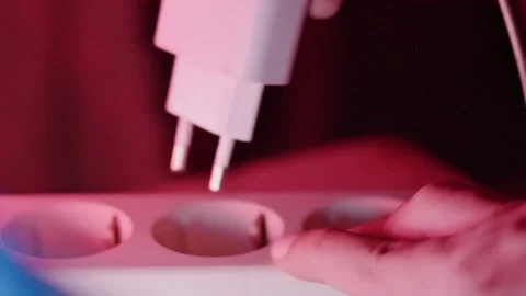 Close Up Hand Plugging and Unplugging White Power Adapter into Socket with .. Stock-Footage 335144103