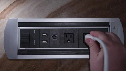 Close-up of a hand plugging cable in charging port socket Stock Footage 241337493