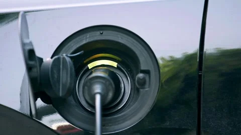 Close up of hand plugging a charger into an electric car Stock Footage 335953241