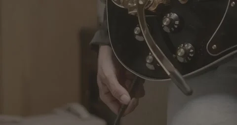 Close-Up of Hand Plugging In Electric Guitar Stock-Footage 323973305