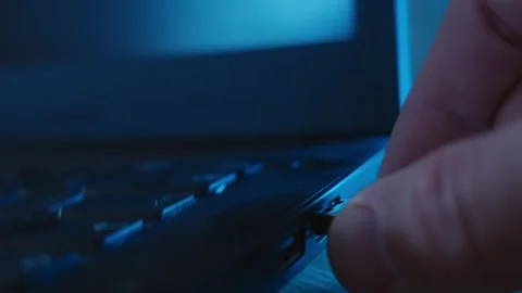 Close up on hand plugging flash drive or memory stick into laptop computer Stock Footage 335180578
