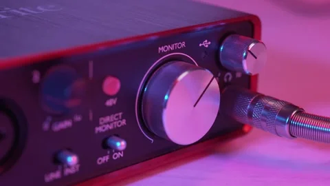Close-Up of Hand Plugging Headphone Jack into Audio Interface Stock Footage 329680860