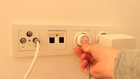 Close up of a hand plugging in a power cord Stock Footage