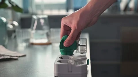 A close-up of a hand plugging a special device against mosquitoes and flies into Video stock 339096820