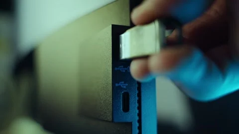 Close up on hand plugging usb drive into computer at night in office or house Stock Footage 336465314