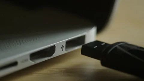 Close Up Hand Plugging USB Flash Drive Into Port On Laptop Computer Stock Footage 112038594