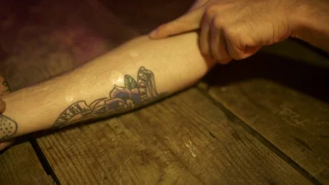 Close up of hand pointing at areas on arm in a tattoo studio Stock Footage 84900788