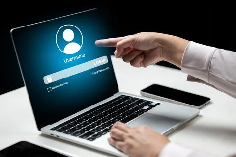 Close-up of a hand pointing at a login screen on a laptop. Concept of cyber.. Stock Photos