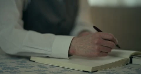 Close up hand pointing over paper map on table in dim indoor light 스톡 동영상 336289244