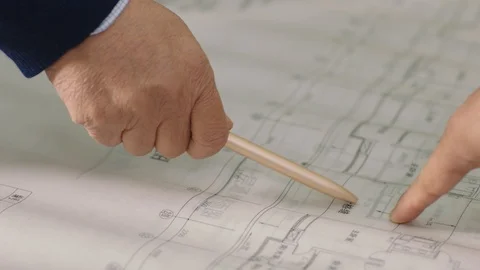 Close-up of hand pointing pen on blueprint when discussing in meeting Video stock 123787352