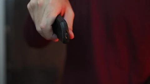 Close Up of Hand Pointing Remote Control Toward Camera Stock Footage 337847396