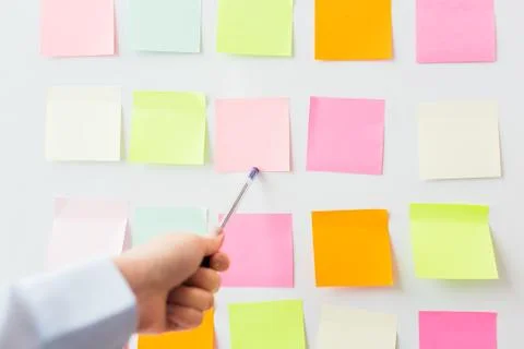 Close up of hand pointing to sticker on flip chart Stock Photos