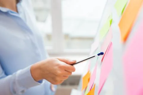 Close up of hand pointing to sticker on flip chart Stock Photos
