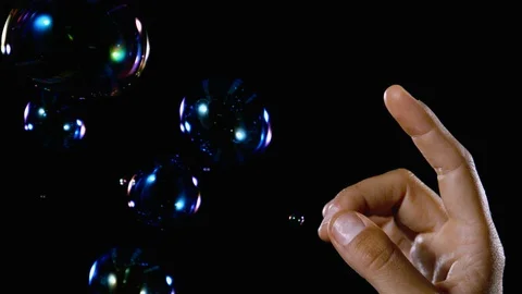 Close up hand popping bubble slow motion on black background Stock Footage 91470220